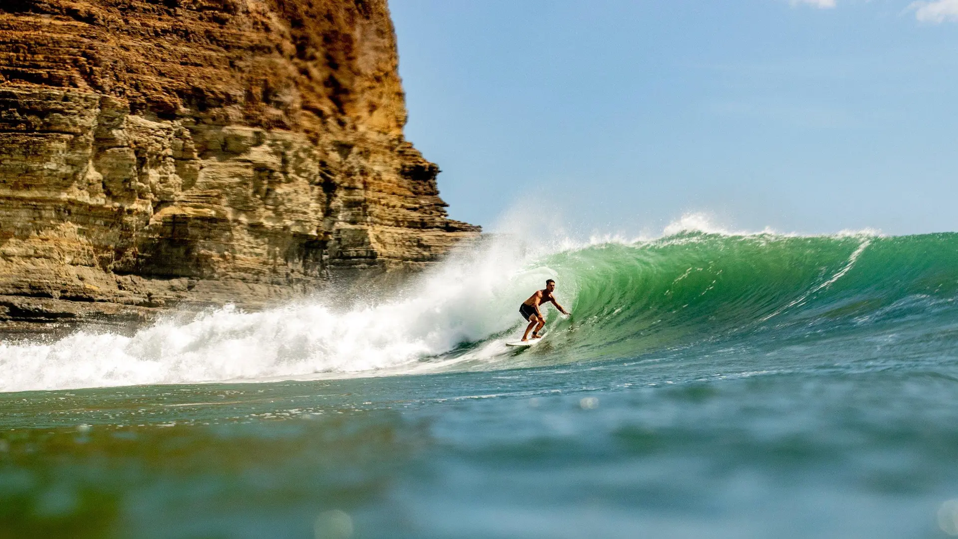 Surfer riding a clean wave at Manzanillo, Nicaragua.