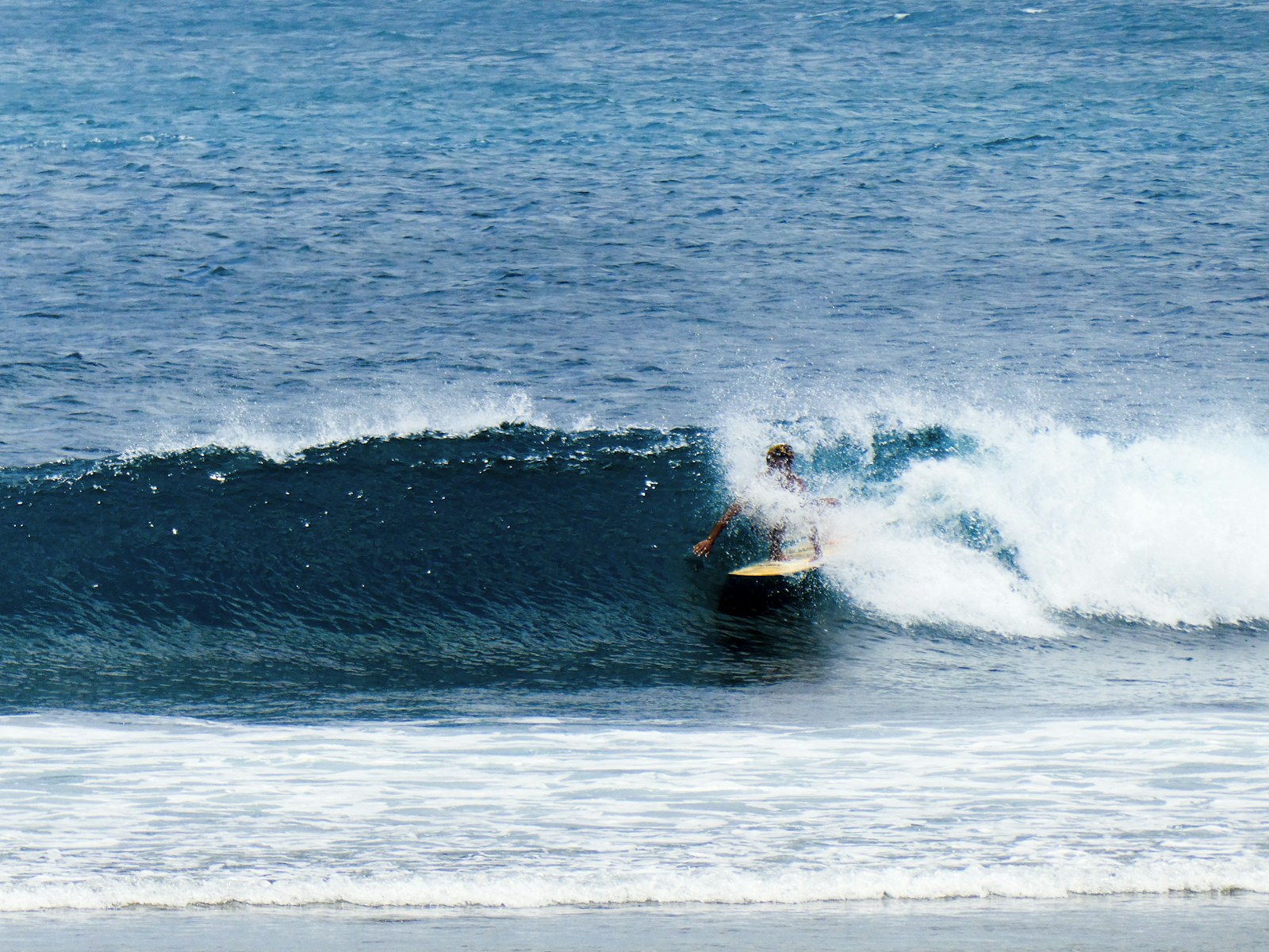 Surfer tucked into a clean Indonesian barrel