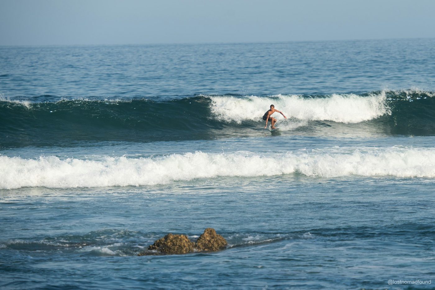 Regional photograph — a surfer riding a wave at San José del Cabo, Baja California Sur, Mexico.