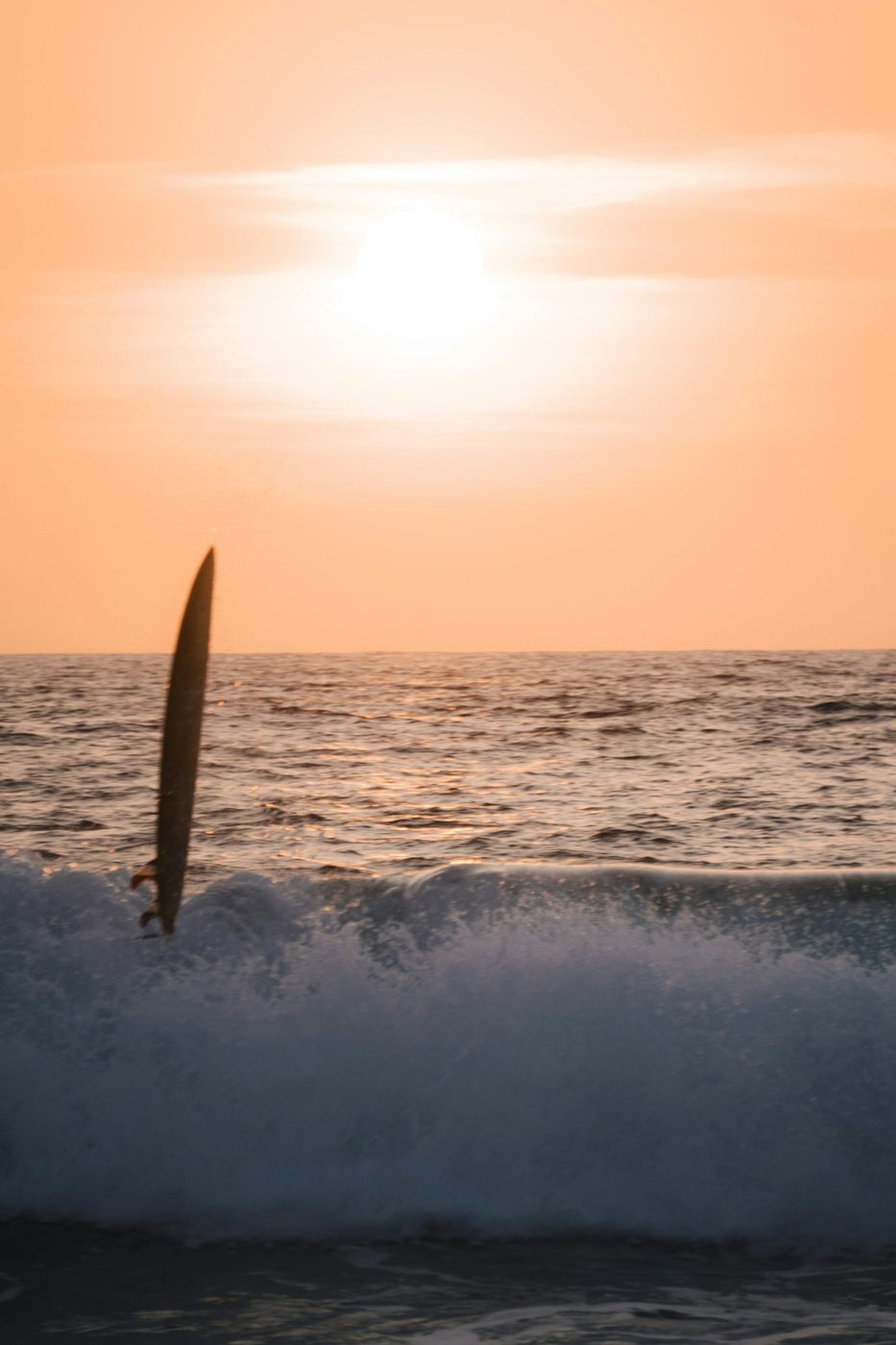 Regional photograph — a surfer and breaking wave at Puerto Escondido, Oaxaca, Mexico.