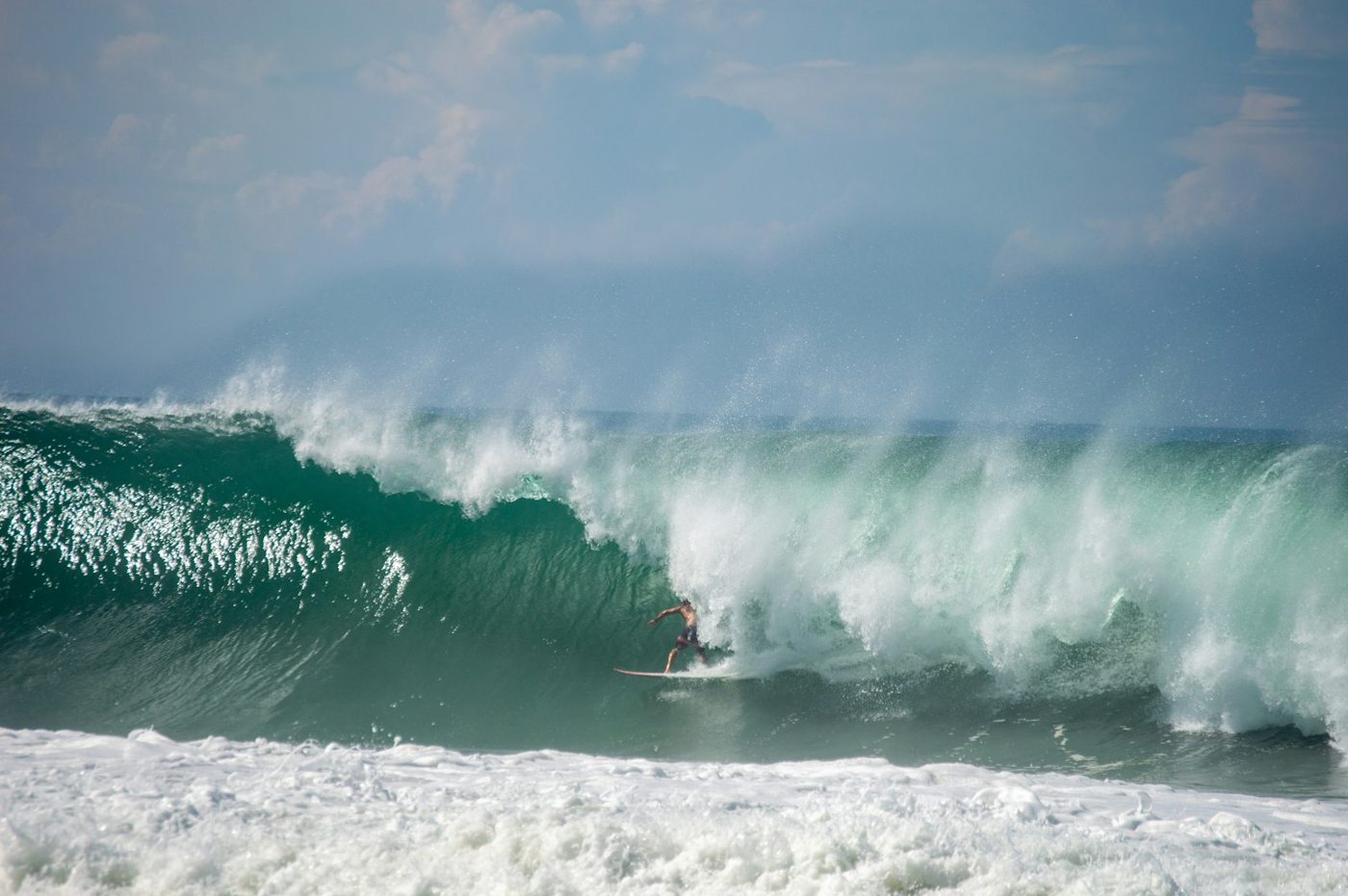 Regional photograph — a surfer on a breaking wave at Playa Zicatela, Oaxaca, Mexico.