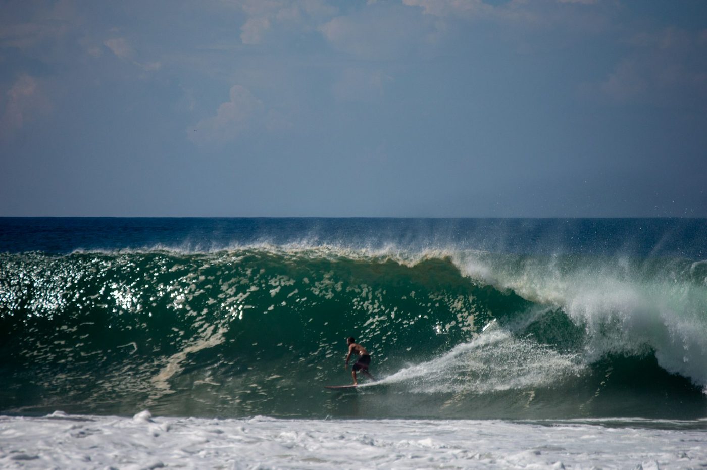 Regional photograph — a surfer on a breaking wave at Playa Zicatela, Oaxaca, Mexico.