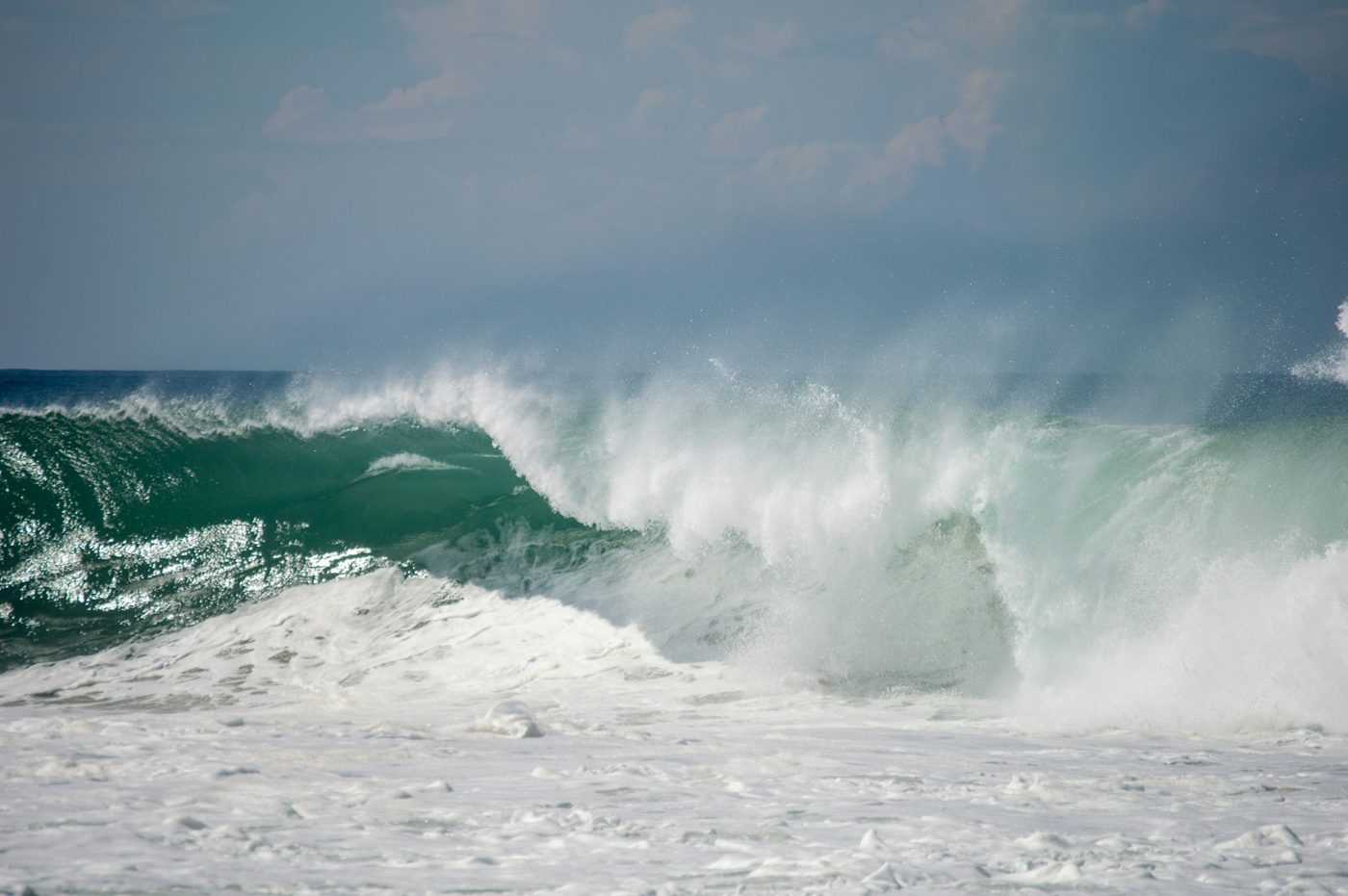 Regional photograph — a surfer on a breaking wave at Playa Zicatela, Oaxaca, Mexico.