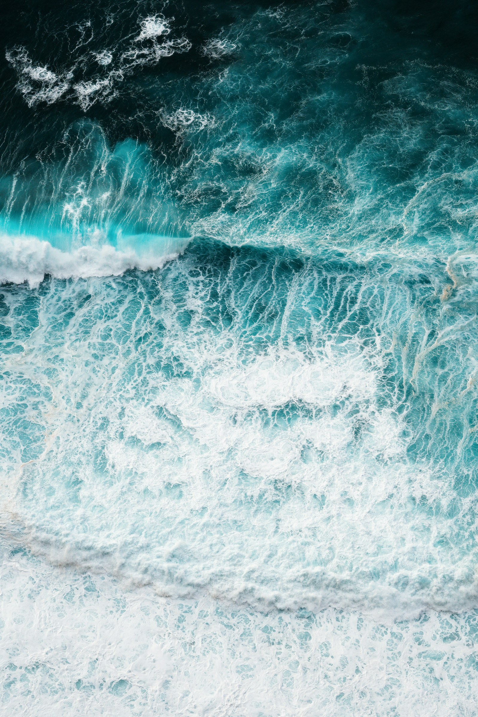 Surfer riding a Madeira wave in early light