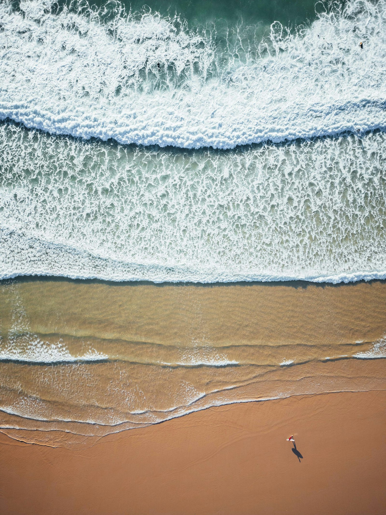 Aerial view of surfers and Atlantic lines at Peniche, Portugal