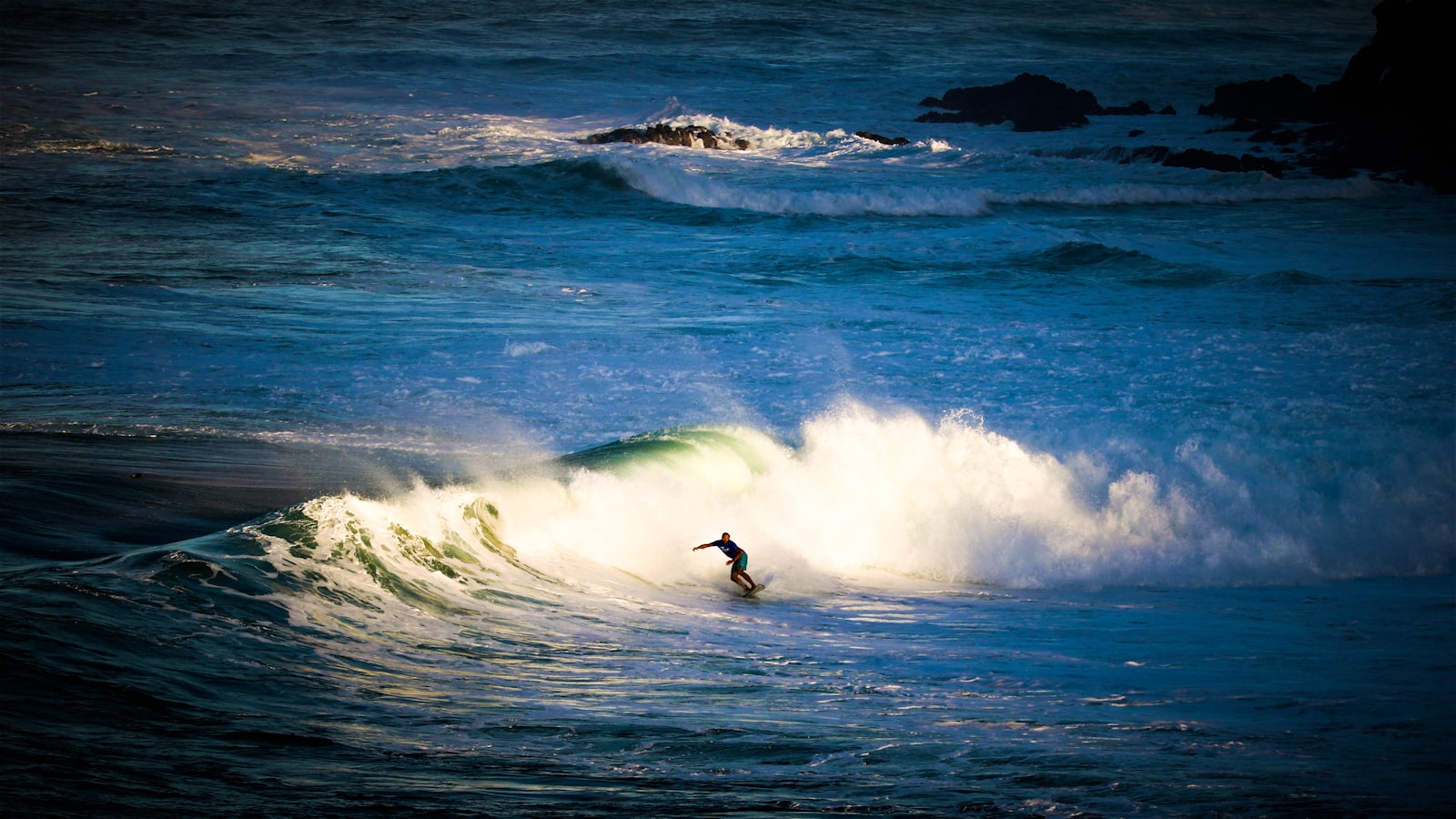 Surfer riding a clean wave in Maui, Hawaii